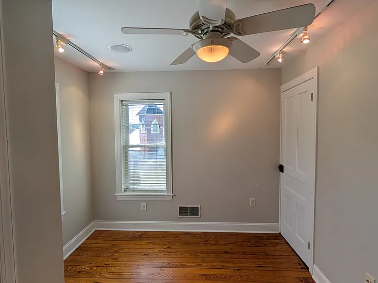 A second bedroom or office on the second floor has a closet, dimmable track lighting and a ceiling fan.