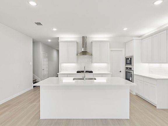 Kitchen in the Masters home plan by Trophy Signature Homes - REPRESENTATIVE PHOTO
