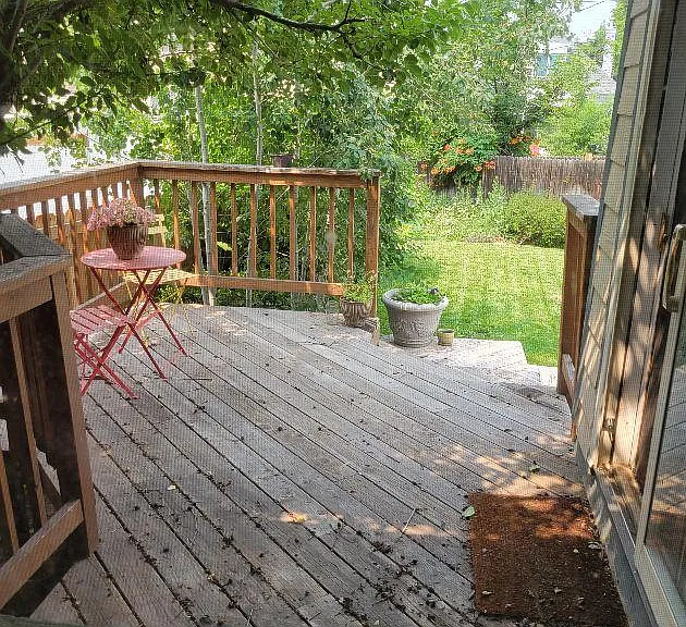 Slip out onto this Shady and spacious deck from the slider in the sunroom.