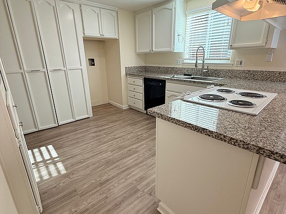 Kitchen with granite counters, laundry closet with hookups