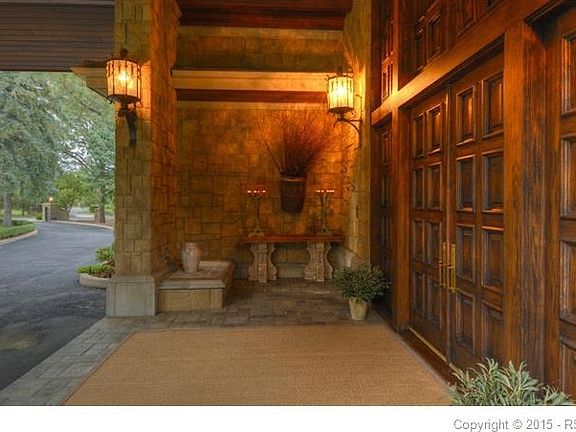 Close up of Port Corchere entrance with original wrought-iron light fixture and amazing 14' front door.