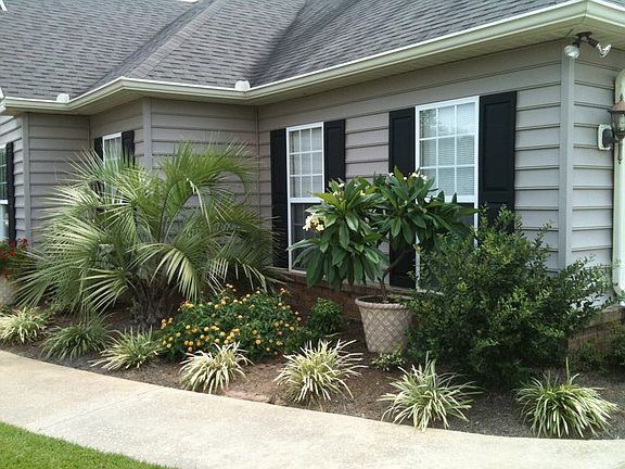 Front flower bed.
						:
						Second view of west end of front flower bed in front of two garage windows.