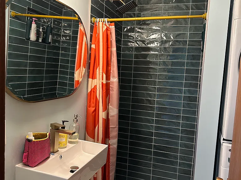 Bathroom with shower and washer and dryer.