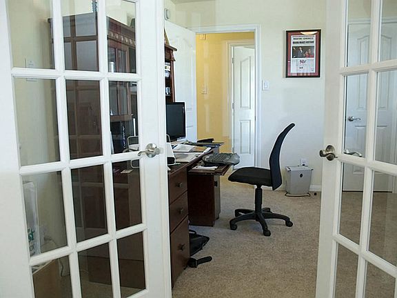 The office off the entry can be accessed through French doors.