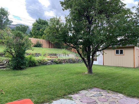 Shed, greenhouse, and large yard