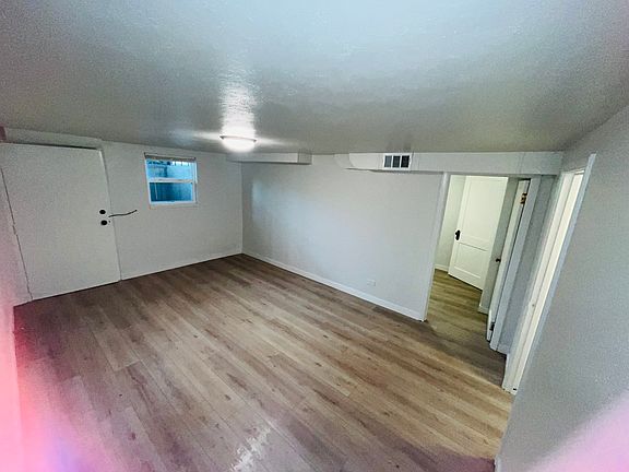 Corner View of Living Room looking at Front Door and Second Bedroom