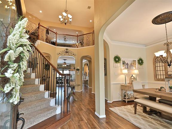 From the front door looking into the grand two-story foyer and open staircase. Imagine how pretty holiday pictures would be on the sweeping staircase.