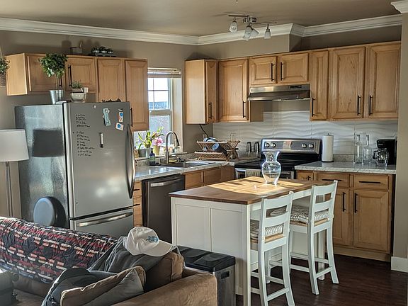 open concept kitchen, updated stainless appliances, modern backsplash, kitchen island