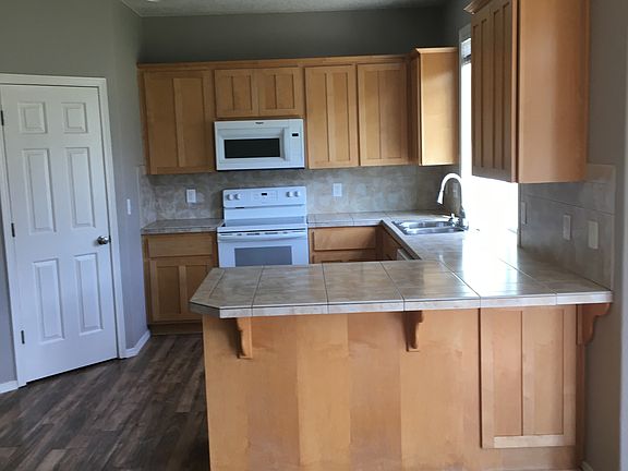Kitchen- Tile countertops and 36 inch maple cabinets