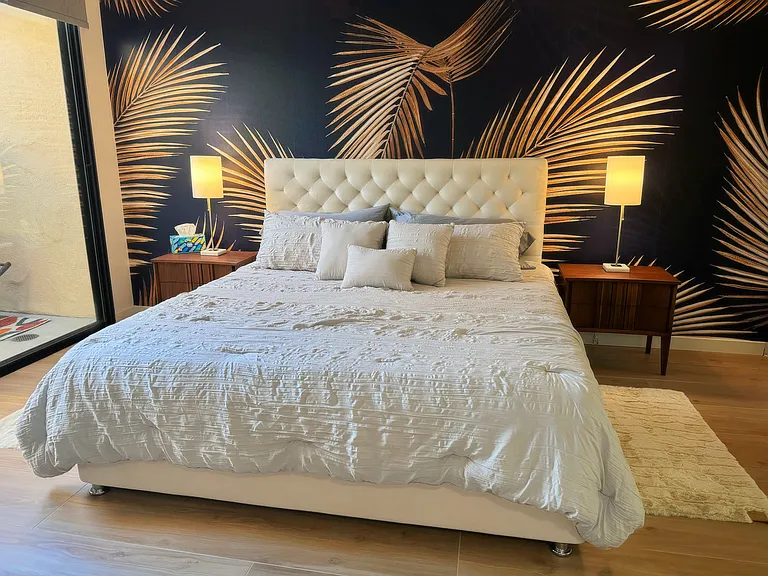 Primary bedroom suite w/ king bed