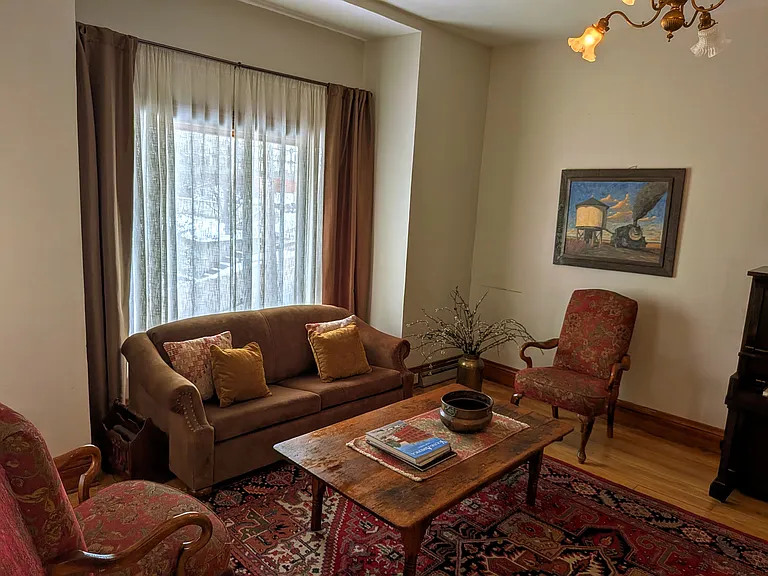 Spacious Living Room with sofa bed and piano.