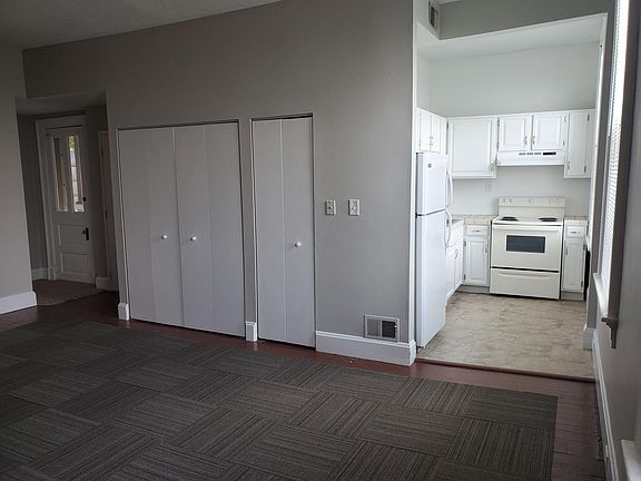 Living/dining area and Kitchen, with side door to small deck.