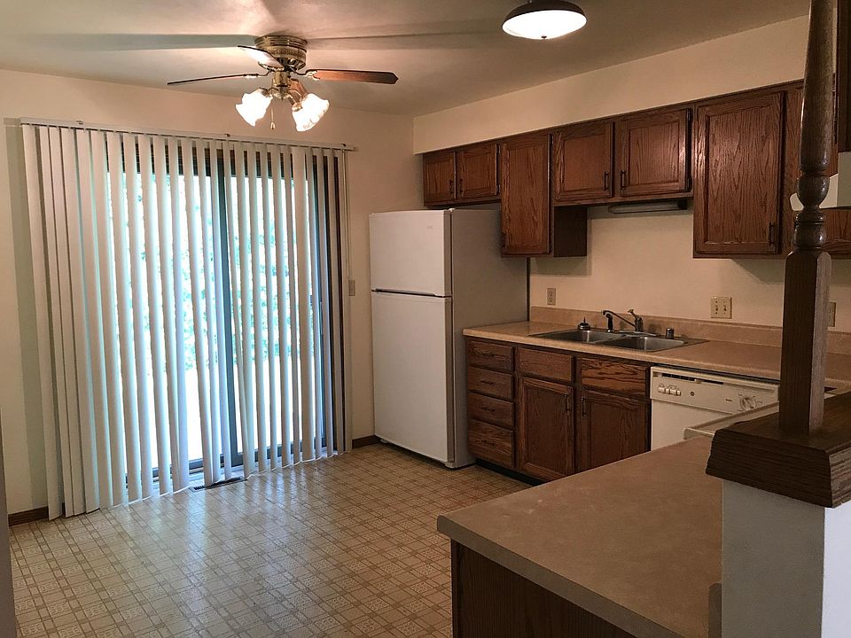 Kitchen with stove, refridgerator and dishwasher.  Patio doo