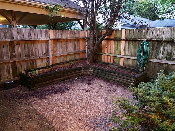 Fenced-in patio area (day).