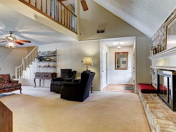 Second floor walk way overlooks family den.