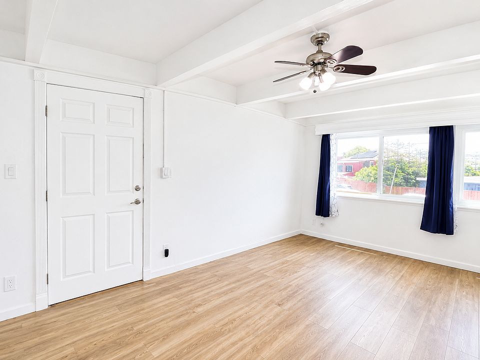 Living room that flows into a dining area, and the kitchen around the corner. It has a half bath downstairs and stairways to go up.