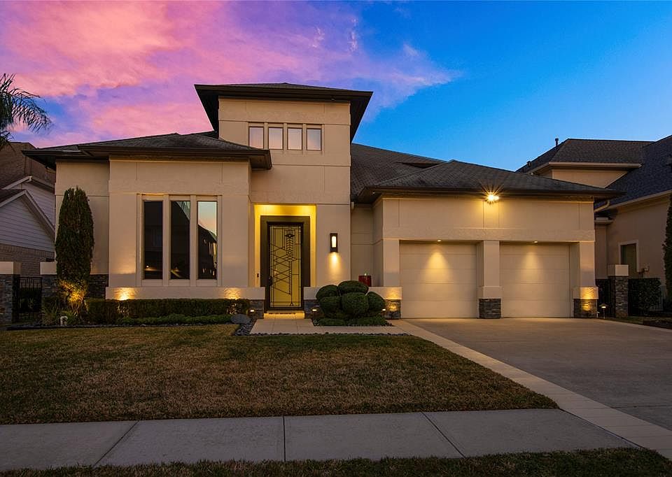 DUSK VIEW OF 746 PEGASUS OFFERING CLEAN CONTEMPORARY ELEMENTS THROUGHOUT. CUSTOM BUILT BY DIMENSION HOMES, IT OFFERS AN ELAN HOME AUTOMATION SYSTEM, BELL BOTTOMED PIER FOUNDATION, TANKLESS WATER HEATERS, CERAMIC COATED WINDOWS AND MUCH MORE! ONE OF T