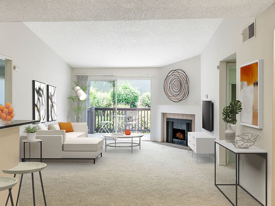 Carpeted Living Room with Fireplace and Balcony