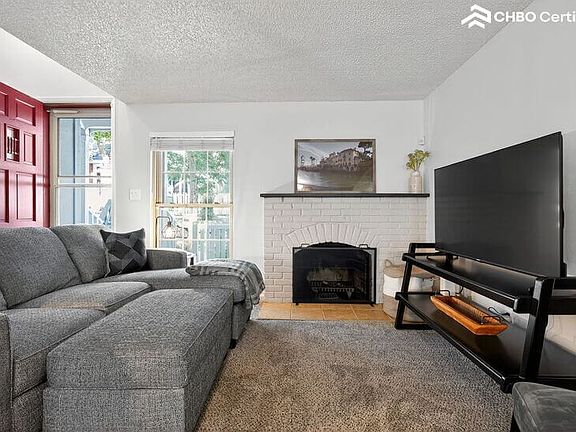 living room with wood burning fireplace