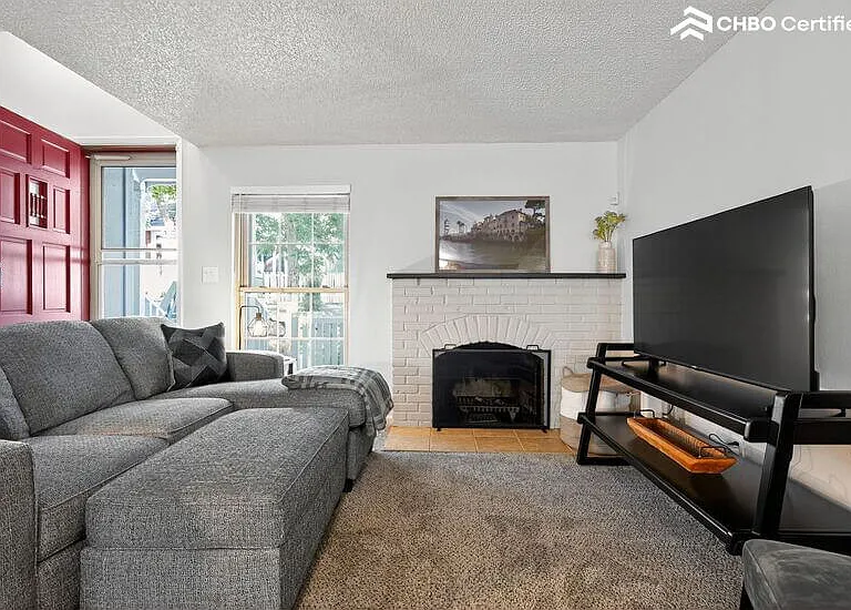 living room with wood burning fireplace