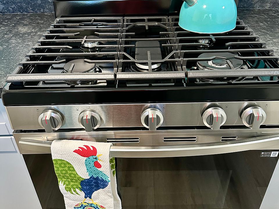 Cooking with gas, Center griddle top is stored below. Self cleaning oven.