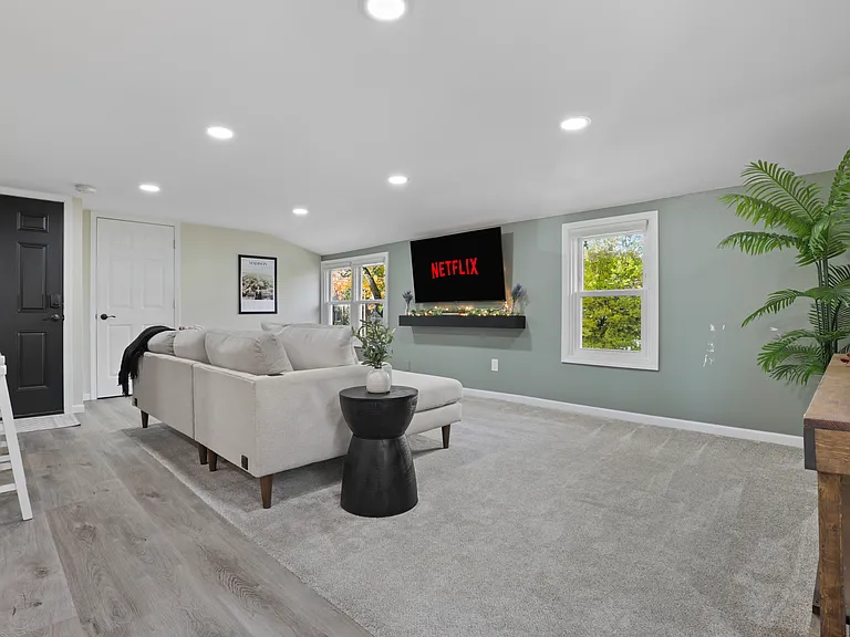 Open concept living with the living room, dining and kitchen area. The living room has a comfy couch, 58" smart TV, and corner swivel chair that's perfect for morning coffee and sight seeing the neighborhood.