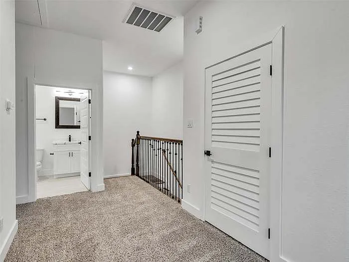Looking back at the stairway. Looking into the second bathroom and laundry room door