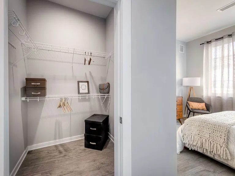 Walk-in closet with linen racks and storage space