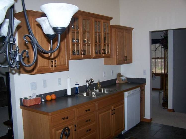 Lots of cupboard space and a tile floor in the kitchen area.