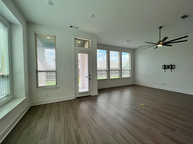 Living and dining with lots of natural light overlooking the back patio.