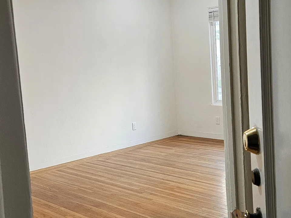 View of main room w/ fandelier from unit #2 interior entry