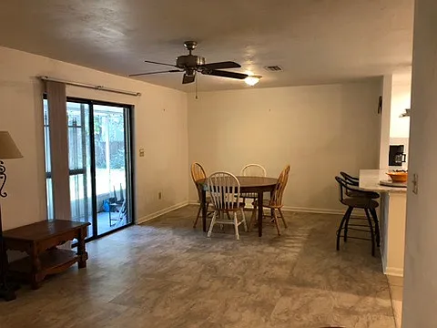 Dining area and sliding glass doors on the left leading to the screened in porch