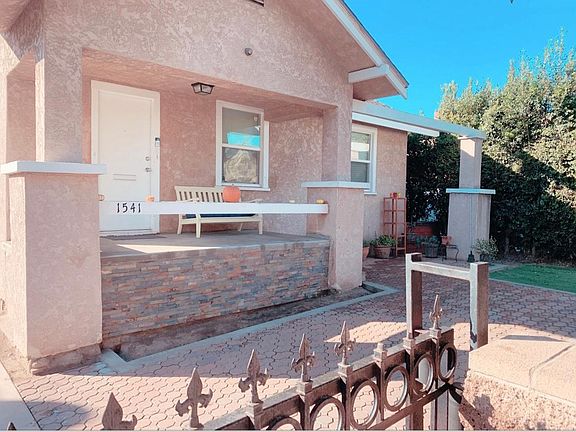 Front of home, large front porch and yard