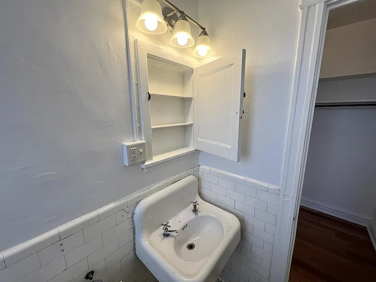 Updated lighting above historic medicine cabinet.