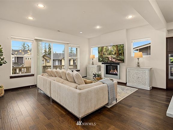 One of the main floor gathering areas features a gas fireplace and sliders that open to the balcony.