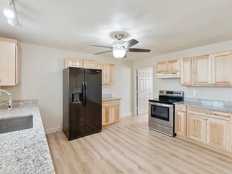 KITCHEN with REFRIGERATOR, RANGE, DISHWASHER & GARBAGE DISPOSAL.
HICKORY CABINETS & GRANITE COUNTERTOPS.