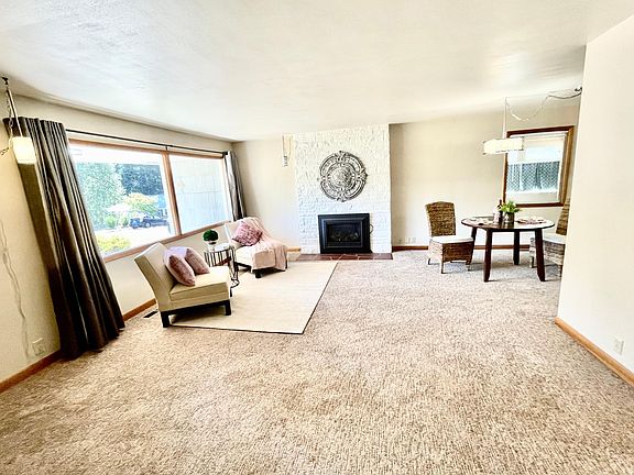 Open Living and dining areas with gas fireplace. Newer carpets! Spacious living room with large picture windows that over looks the covered front porch. Gas fireplace and pocket door that separates the living room from the hall.