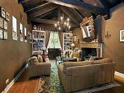 Living Room w/original beamed, vaulted ceiling, hand-carved fireplace;