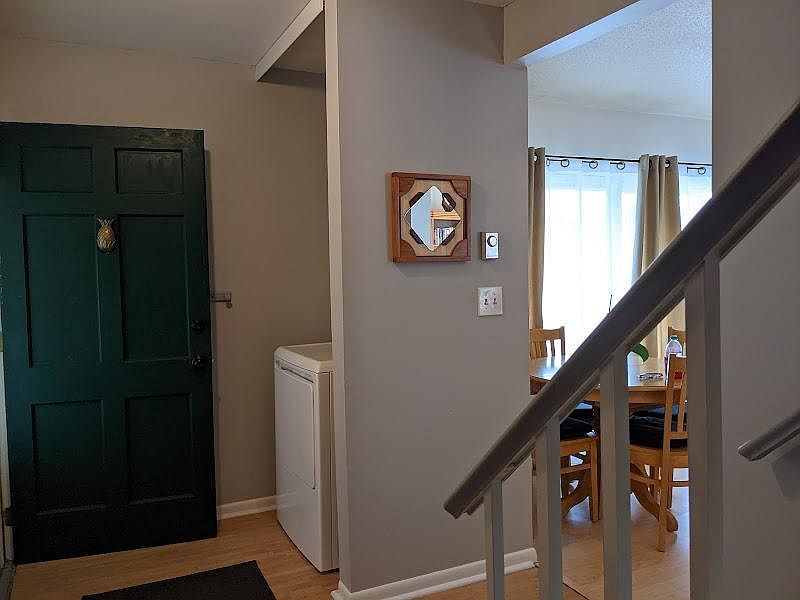Dryer, stairs, and living room