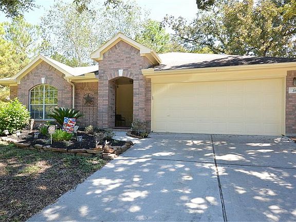 The 2 car garage has extra parking space under the shade tress.