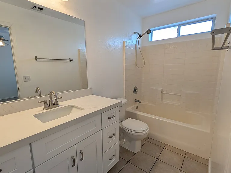 A clean, modern bathroom located directly inside the main bedroom suite.