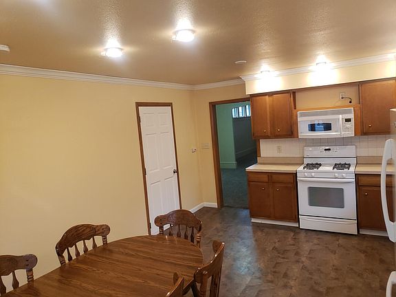 Kitchen includes "Over-The-Range" Microwave, oven, refrigerator with icemaker, & dishwasher. Also includes two bay windows, solid surface wink, and LED lighting. Also includes vinyl plank flooring, tile backsplash, & crown molding.