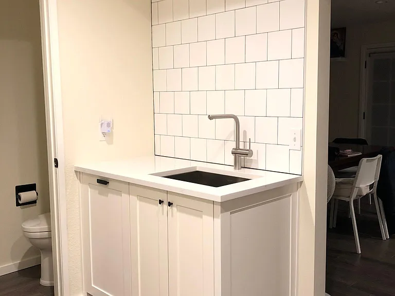 Utility room sink with same quartz countertop as kitchen