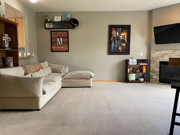 Large living room with gas fireplace, window open to kitchen so you're part of the action even when you're cooking!