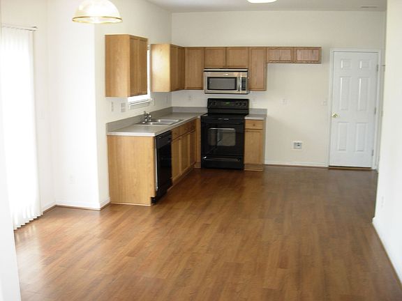 Large Kitchen with oak cabinets & a laminate wood floor