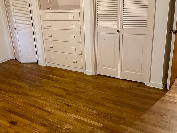 Main bedroom with wood floors, and ample built-in storage and closet space