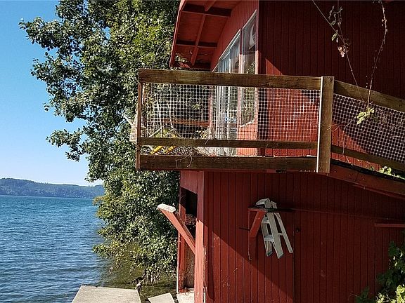 Panaramic views await you on this 242' beach. Boathouse is established but in need of repair.  Photo shows water at high tide looking North across Hood Canal.