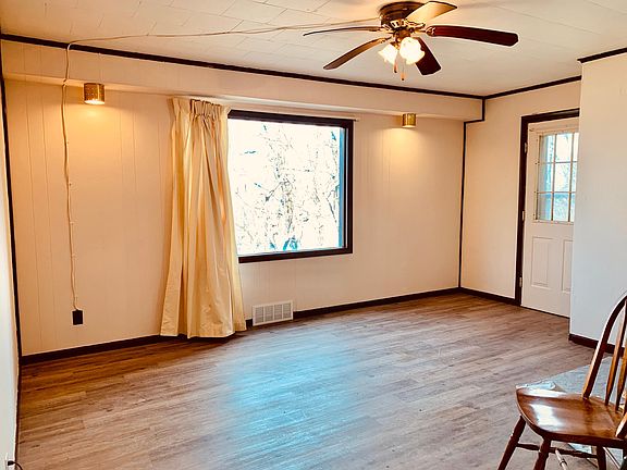 New floors with the big picture window and freshly painted walls with the color vanilla ice cream.