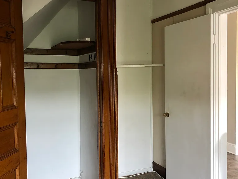 Bedroom closet and door facing the kitchen