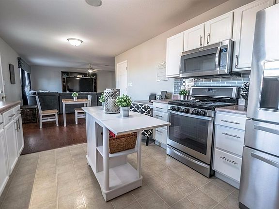 RECENTLY UPDATED KITCHEN W/WHITE CABINETS, LEVERS, ISLAND, BUILT-IN DESK, BACKSPLASH, UPGRADED FAUCET, HIGH END STAINLESS STEEL APPLIANCES, PANTRIES & MORE!